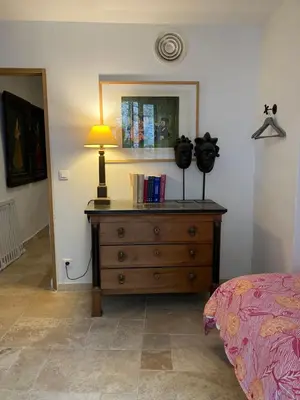 a bedroom with a dresser with a lamp on it at Maison de village en Provence Luberon in Saint-Saturnin-les-Apt