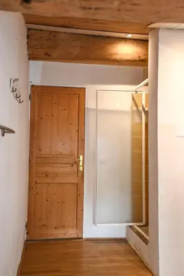 a room with a wooden door and wooden ceilings at Maison provençale avec piscine et vue in Viens