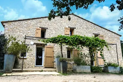 an old stone house with wooden doors at Maison provençale avec piscine et vue in Viens