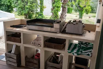a kitchen counter with a toaster oven on top of it at La Maison PP une Parenthèse Provençale in Carpentras