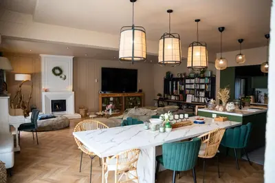 a living room with a large white table and chairs at La Maison PP une Parenthèse Provençale in Carpentras