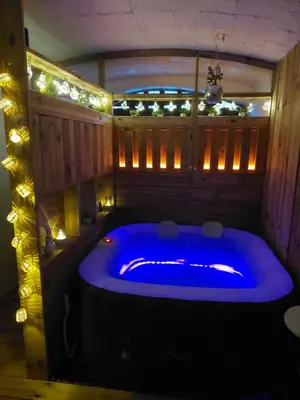 a large blue tub in a room with lights at Maison privée billard spa dans village du Luberon in Cabrières-dʼAigues