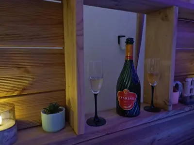 a bottle of wine and two glasses on a shelf at Maison privée billard spa dans village du Luberon in Cabrières-dʼAigues