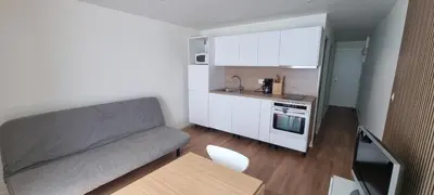 a small living room with a couch and a kitchen at Appartement in Aix-en-Provence