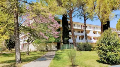 a large white building with trees in front of it at Appartement in Aix-en-Provence
