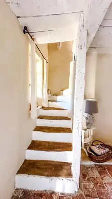 a stairway leading up to a room with white walls at Hameau de l'Esperelle in Simiane-la-Rotonde