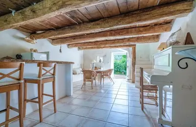 a kitchen and dining room with a table and chairs at Hameau de l'Esperelle in Simiane-la-Rotonde