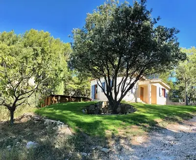 a house with a tree in the yard at Gite PROVENCE MONT VENTOUX in Malemort-du-Comtat