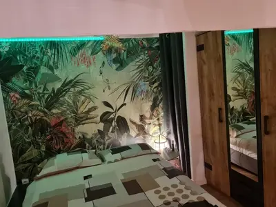 a bedroom with a mural of plants on the wall at City break in old center Aix! in Aix-en-Provence