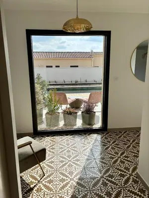a mirror in a room with potted plants at Villa moderne au coeur de la provence in Pernes-les-Fontaines