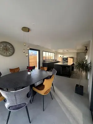 a dining room and kitchen with a table and chairs at Villa moderne au coeur de la provence in Pernes-les-Fontaines