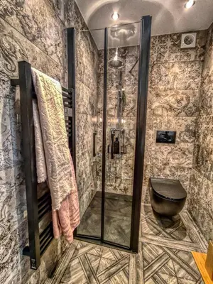 a bathroom with a walk in shower and a toilet at Suite d'exception, luxe, élégance et raffinement in Aix-en-Provence