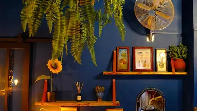 a blue wall with a fan and a wooden table at Suite d'exception, luxe, élégance et raffinement in Aix-en-Provence