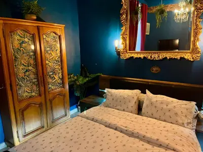 a bedroom with a bed with a mirror and a dresser at Suite d'exception, luxe, élégance et raffinement in Aix-en-Provence