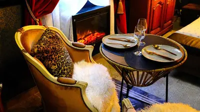 a dining room with a table and chairs and a fireplace at Suite d'exception, luxe, élégance et raffinement in Aix-en-Provence