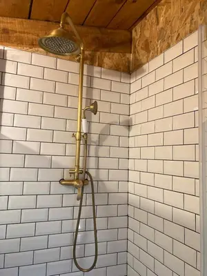 a shower in a bathroom with white tiles at Le Cabanon d 'Aix in Aix-en-Provence