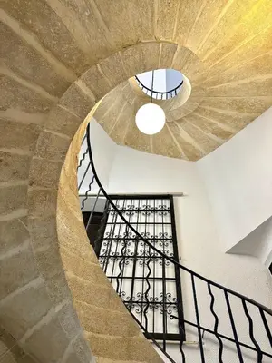 a spiral staircase in a building with a ceiling at Charmant T2 à deux pas du cours Mirabeau in Aix-en-Provence