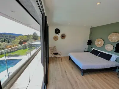 a bedroom with a bed and a balcony at Villa Moderne 5 chambres - Aix-En-Provence - piscine in Le Tholonet