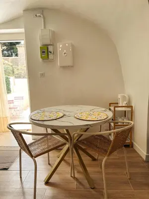 a table with two plates on it in a room at Cosy Cœur Alpilles, T2 neuf in Aureille