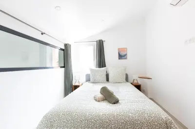 a bedroom with a bed with a pillow on it at Le Duplex des Ocres - 2 bedrooms - Air conditioning - WiFi in Apt