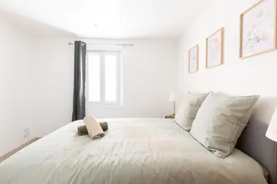 a bedroom with a bed with a stuffed animal on it at Le Duplex des Ocres - 2 bedrooms - Air conditioning - WiFi in Apt