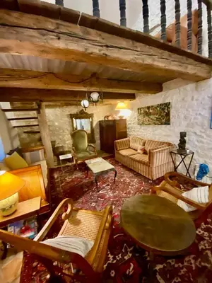 a living room with a couch and a table at La Mistraline, in the center of the Luberon, Provence 2 bedroom, 2 bath Village House in Caseneuve