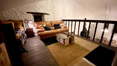 a living room with a couch and a coffee table at La Mistraline, in the center of the Luberon, Provence 2 bedroom, 2 bath Village House in Caseneuve