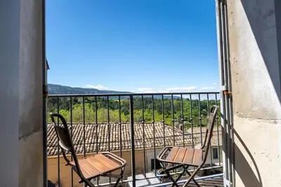two chairs sitting on a balcony with a view at Chez Marthe - Maison de village - Ménerbes centre in Ménerbes