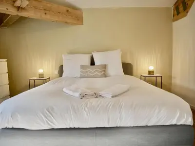 a bedroom with a white bed with two night stands at Les Calanques - Mas des Sous-Bois in Ventabren