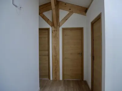 two wooden doors in a room with wooden floors at Les Calanques - Mas des Sous-Bois in Ventabren