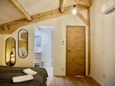 a bedroom with a bed and a wooden ceiling at Les Calanques - Mas des Sous-Bois in Ventabren