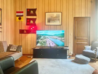 a living room with a flat screen tv on a wall at Bourgeois House - 16 personnes, Piscine, 6 chambres, 8 lits, 4 SDB, Centre-ville, CLIM in Salon-de-Provence