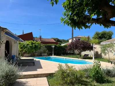 a swimming pool in the backyard of a house at Joli rez de villa proche d'Aix-en-Provence in Peyrolles-en-Provence