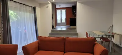 a living room with a couch and a table at Appartement de la Villa Del Sol in Pierrevert