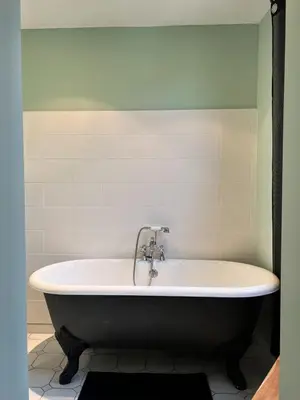 a bath tub with a faucet in a bathroom at Elivi Elegant Art Deco house with Garden Walk to the Heart of Town in LʼIsle-sur-la-Sorgue