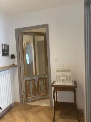 a room with a door and a table with a mirror at Elivi Elegant Art Deco house with Garden Walk to the Heart of Town in LʼIsle-sur-la-Sorgue