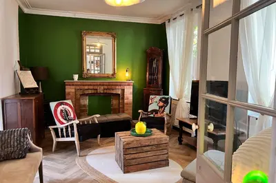 a living room with green walls and a fireplace at Elivi Elegant Art Deco house with Garden Walk to the Heart of Town in LʼIsle-sur-la-Sorgue