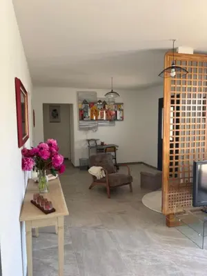 a living room with a vase of flowers on a table at 