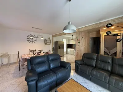 a living room with a couch and a table at Maison Tamaris in LʼIsle-sur-la-Sorgue