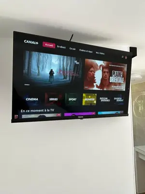 a flat screen tv hanging on a wall at L'Essentiel Room in Velaux