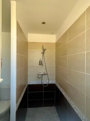 a bathroom with a shower and a toilet at Chambre L in Les Taillades