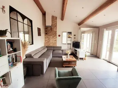 a large living room with a couch and a table at Maison Viens in Viens