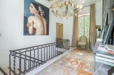 a staircase in a home with a painting on the wall at 18Th Century Bastide With Heated Pool In Provence in Apt