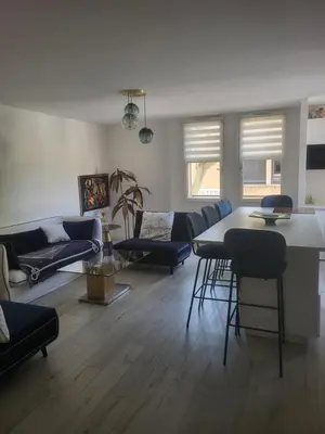 a living room with a couch and a table and chairs at Espace Forbin in Aix-en-Provence