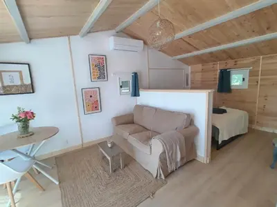 a room with a couch and a bed and a table at La Ch'tite Maison in Céreste