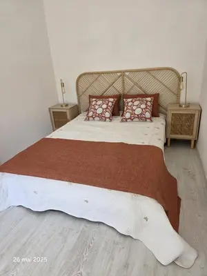 a bedroom with a large bed with red pillows at La Pineda de Provence in Aix-en-Provence