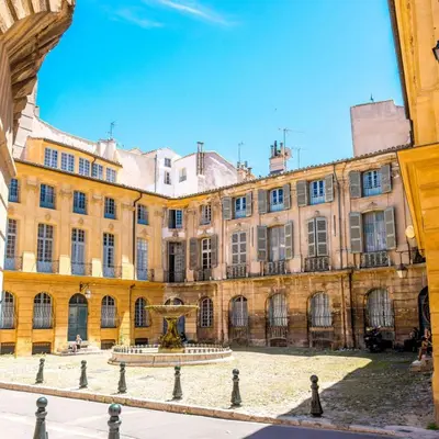 a large building with a fountain in front of it at La Pineda de Provence in Aix-en-Provence