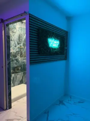 a blue light in a room with a clock on the wall at Trésor Étoile, luxe & lumière - Duplex 4 personnes in Pertuis