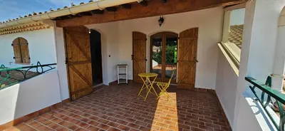 a porch of a house with a table and chairs at Villa en Provence avec piscine in Sénas