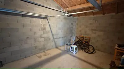 a bike parked in a room with a brick wall at Cap sur le Ventoux in Mormoiron